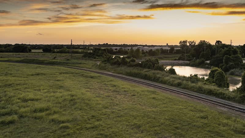 Sunset in Sugar Land, Texas with a view of the creek and railroad.